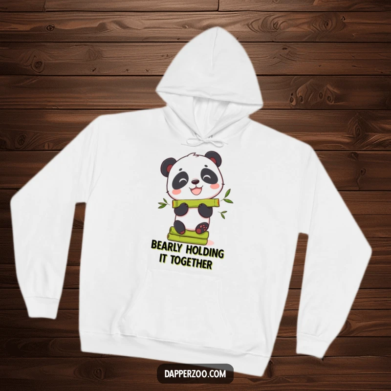 Funny panda hoodie featuring a grinning bear character precariously balancing a stack of bamboo shoots.