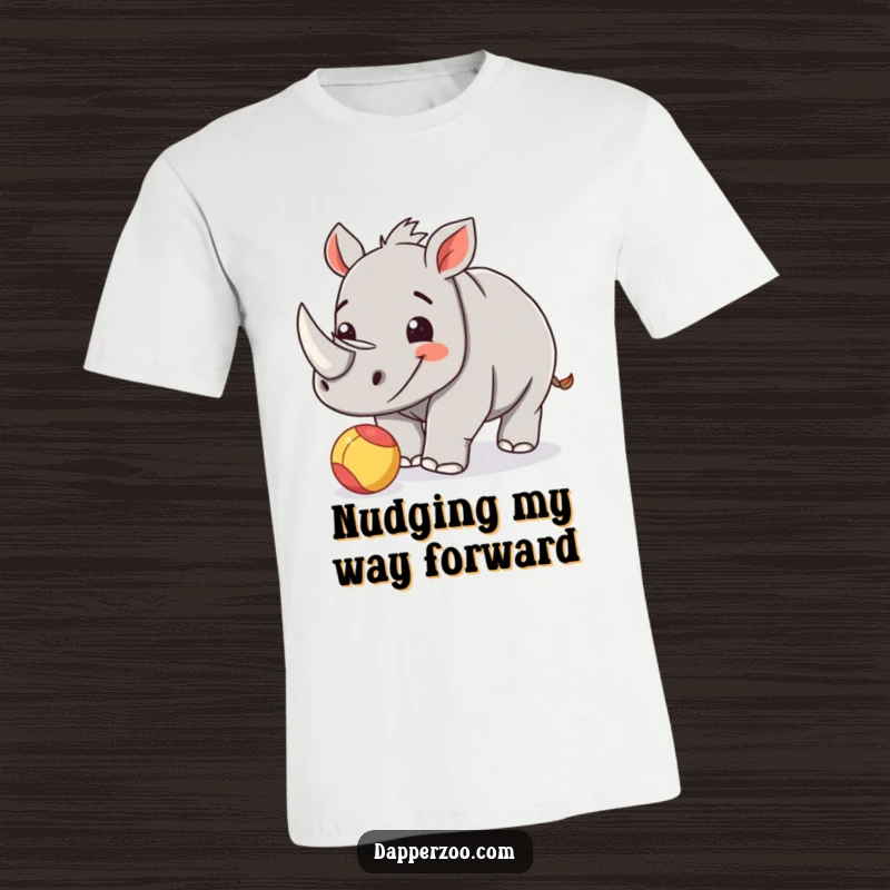 Funny rhinoceros calf t-shirt featuring a happy calf playfully nudging a tiny, colorful ball.